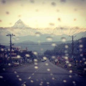 Staggering mountain range viewed from a rainy car window